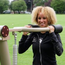 closer crop image of woman using urbanix proludic outdoor gym at jubilee park in knowsley